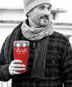 A Man in a Scarf In Black and White Holding a Red Cup